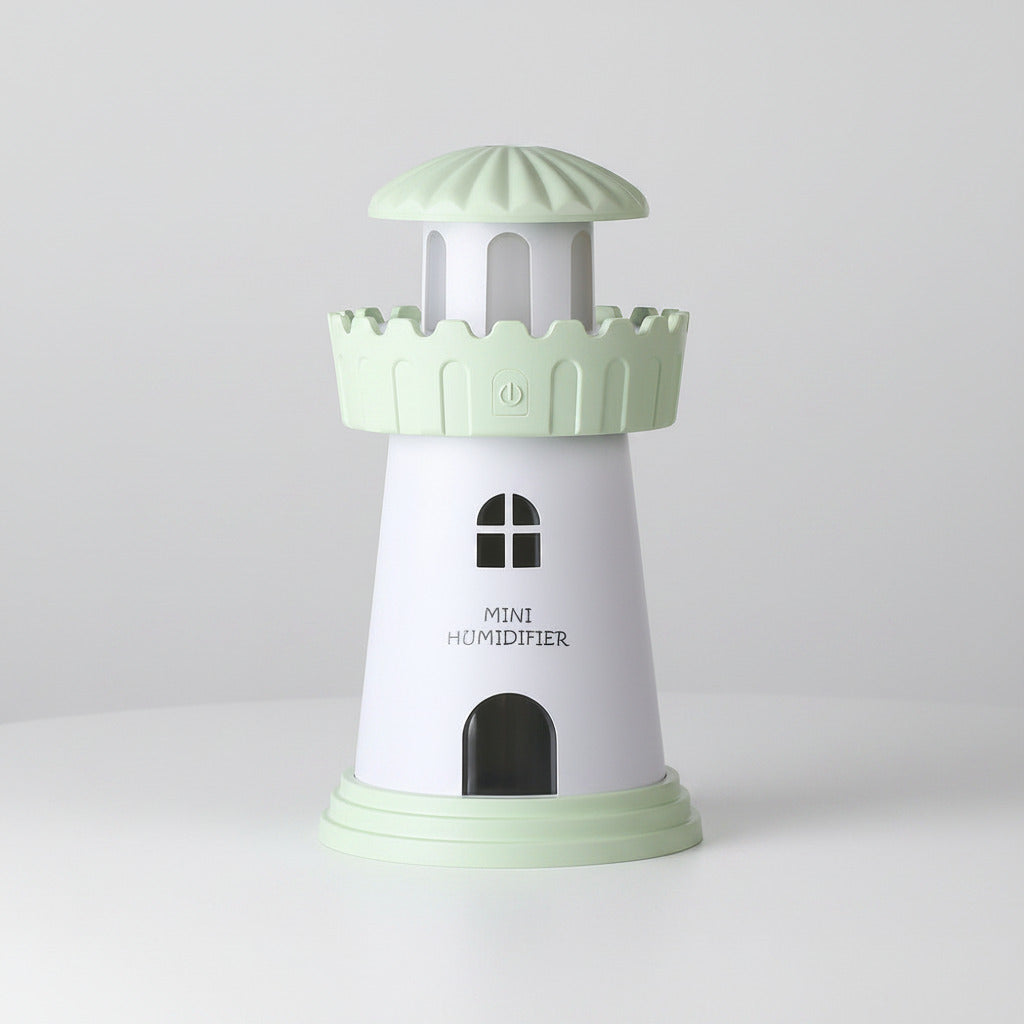Mini humidifier designed like a lighthouse with a light green top and base on a white background.
