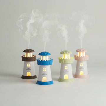 Set of colorful lighthouse-shaped humidifiers emitting mist on a surface.